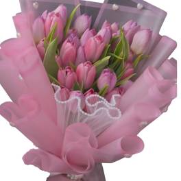 Pink tulip bouquet wrapped in translucent pink paper