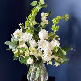 White floral arrangement in a clear glass vase