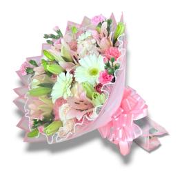 Pink and white bouquet with lilies, daisies, and roses wrapped in pink paper
