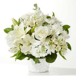 White flowers arranged in a clear basket vase