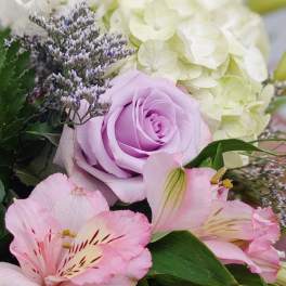 Bouquet of pink lilies, lavender rose, and white hydrangea