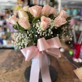 Bouquet of pale pink roses with baby's breath and a pink ribbon