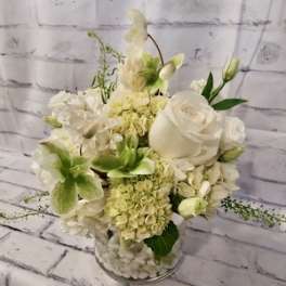White floral arrangement in a clear glass vase