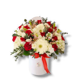 Red roses and white daisies in a white hatbox with a red ribbon
