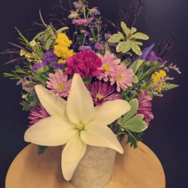 Mixed bouquet with a large white lily in a metal container