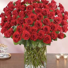 Large bouquet of red roses in a clear glass vase