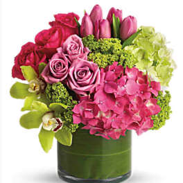 Pink roses and tulips with hydrangea in a glass vase