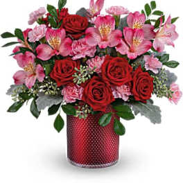 Red roses and pink alstroemeria in a red vase