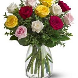 Bouquet of multicolored roses in a clear glass vase
