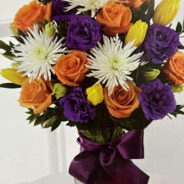 Bouquet of orange and purple roses with white spider mums and yellow tulips