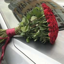 Bouquet of red roses tied with a burgundy ribbon