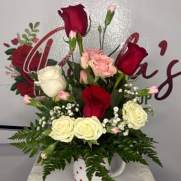 Mixed rose bouquet in a white mug with red hearts