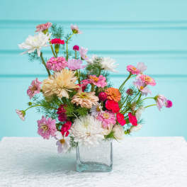Mixed pink and white flowers in a clear glass vase