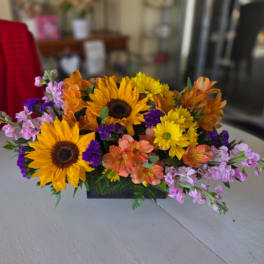 Mixed bouquet with sunflowers, orange alstroemeria, and purple filler flowers