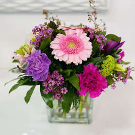 Pink and purple mixed bouquet in a clear glass vase