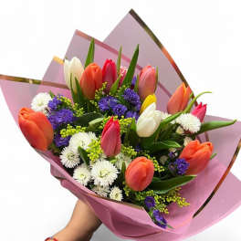Bouquet of multicolored tulips with white and purple filler flowers