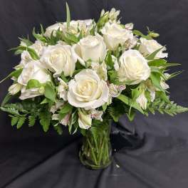 White rose bouquet in a clear glass vase