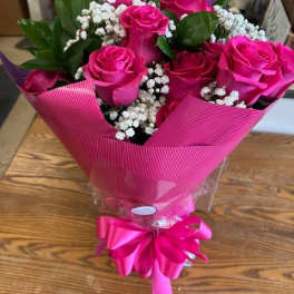 Bouquet of hot pink roses with baby's breath wrapped in pink paper