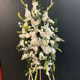 Tall white floral standing spray on an easel