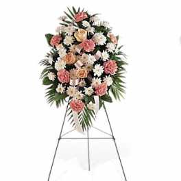 Standing floral spray with pink and white flowers on an easel