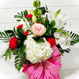 Bouquet of white lilies, hydrangeas, and red carnations with a pink striped ribbon