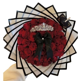 Heart-shaped bouquet of red roses with a black ribbon and tiara