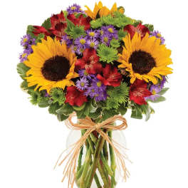 Bouquet of sunflowers, red alstroemeria, and purple daisies in a glass vase