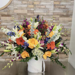 Large mixed bouquet in a white hatbox with yellow roses and lilies