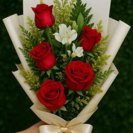 Bouquet of red roses and white flowers wrapped in cream paper