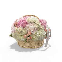 Pink and white flower arrangement in a wicker basket