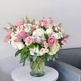 Pink and white rose bouquet in a glass vase
