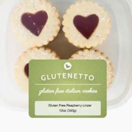 Container of heart-shaped raspberry linzer cookies