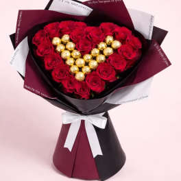 Heart-shaped bouquet of red roses with gold chocolates in decorative wrap