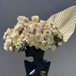 Cream rose bouquet with orchids and hydrangeas in a black holder