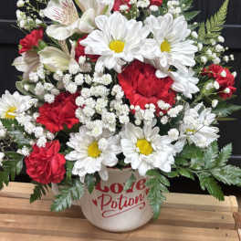 Red and white mixed bouquet in a mug-shaped vase