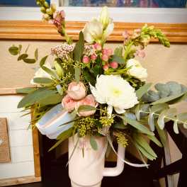 Mixed bouquet in a pink tumbler with white and pink flowers