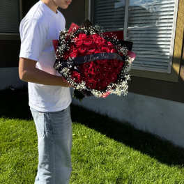 Large bouquet of red roses with baby's breath and a ribbon
