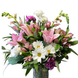 Pink lilies and white daisies in a glass vase
