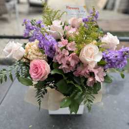 Bouquet of pink and white roses with purple flowers