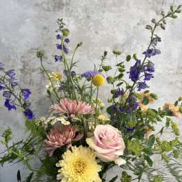 Mixed bouquet with pink roses, yellow chrysanthemums, and purple flowers