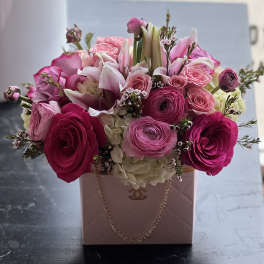 Pink and white flower arrangement in a blush handbag-style box
