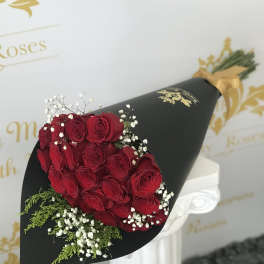 Bouquet of red roses with baby's breath in black wrap