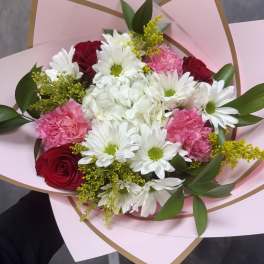 Bouquet of red roses, white daisies, pink carnations, and white hydrangea