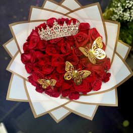 Bouquet of red roses with a jeweled crown and gold butterfly decorations