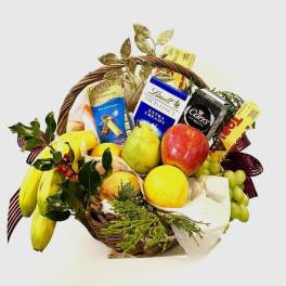 Fruit basket with chocolates and ribbon on a white background