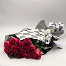 Bouquet of red roses wrapped in black and white paper
