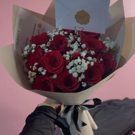 Bouquet of red roses with white baby's breath in beige and blue wrap