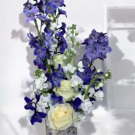 Blue and white floral arrangement in a patterned vase