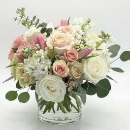 Pink and white rose bouquet in a clear glass vase