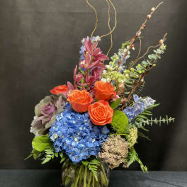Colorful mixed flower arrangement in a glass vase